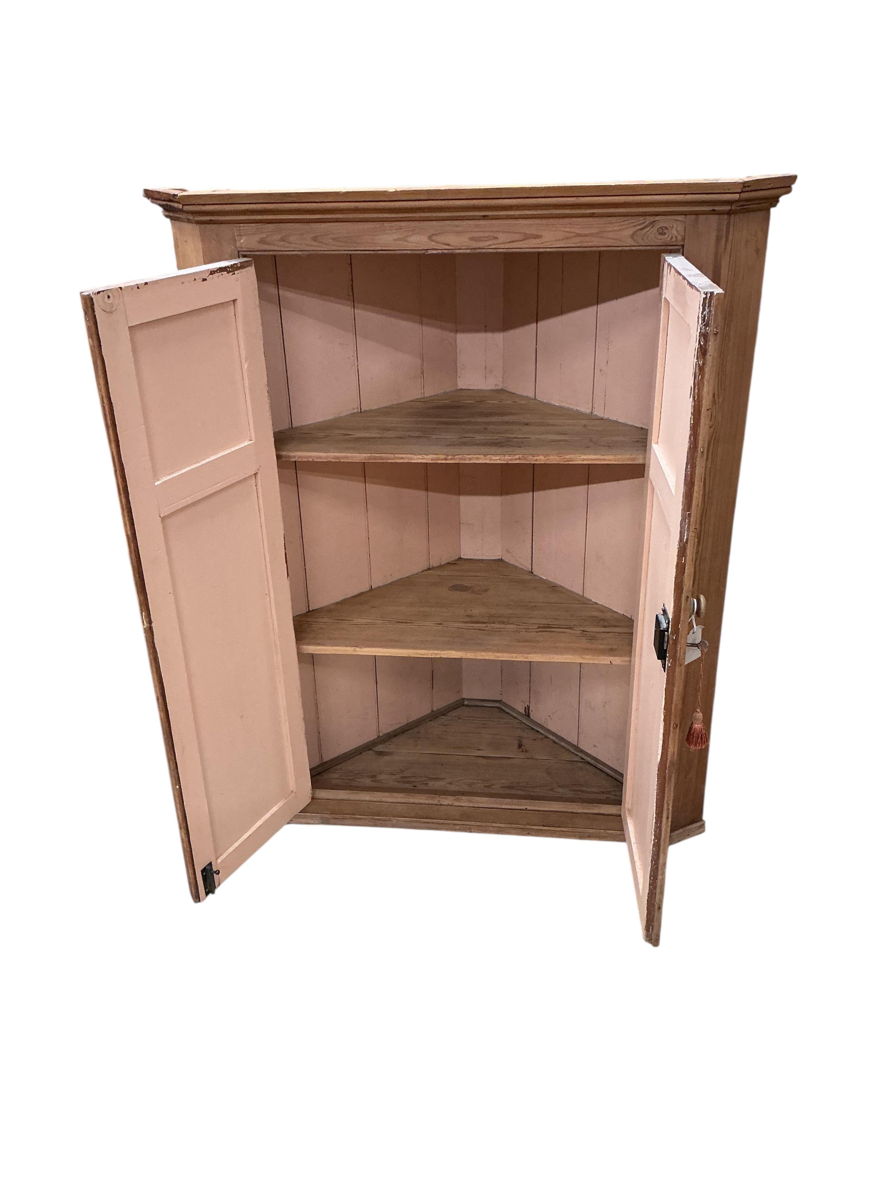 A Victorian panelled pine hanging corner cabinet, width 102cm, depth 53cm, height 126cm